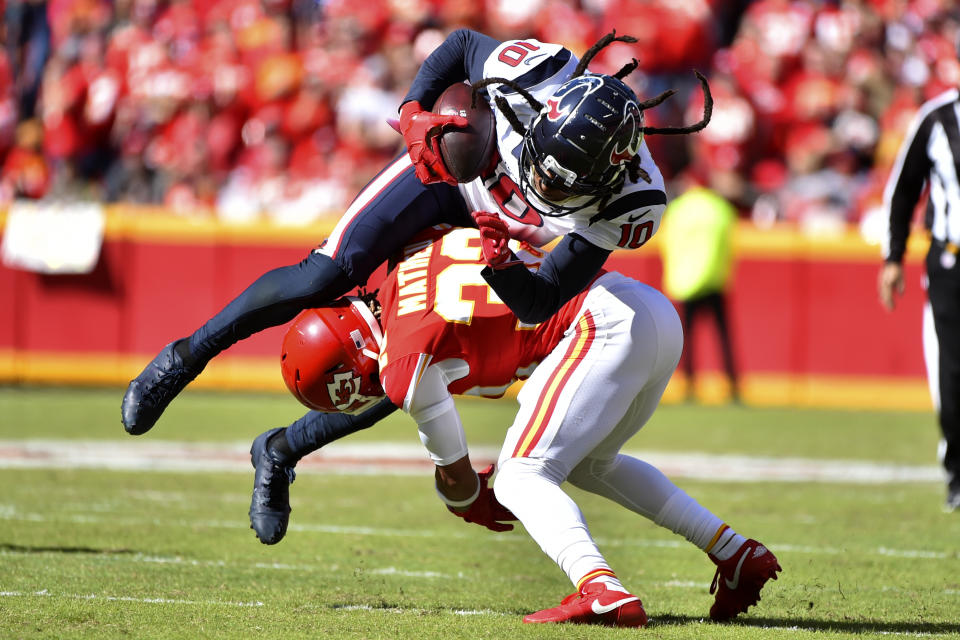 Houston Texans wide receiver DeAndre Hopkins (10) is upended by Kansas City Chiefs safety Tyrann Mathieu (32) during the first half of an NFL football game in Kansas City, Mo., Sunday, Oct. 13, 2019. (AP Photo/Ed Zurga)