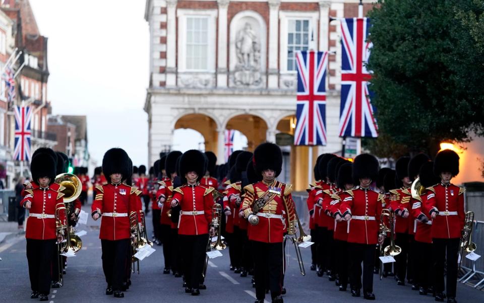 Members of the Band of the Grenadier Guards march down the High Street in Windsor following an early morning rehearsal for the funeral of Queen Elizabeth I - Andrew Matthews