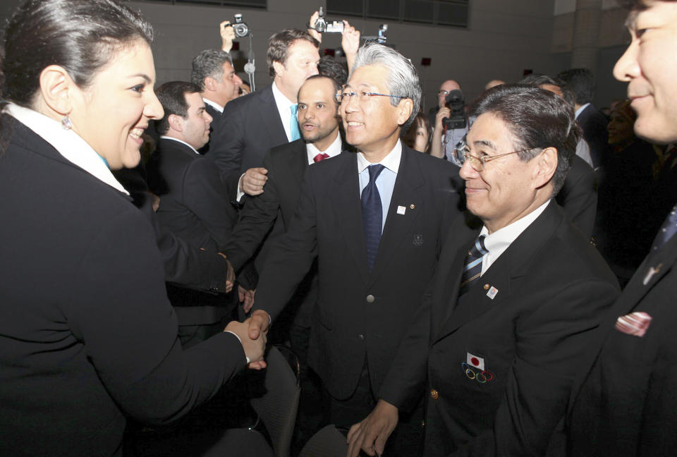 In this photo released by Japanese Olympic Committee, Tsunekazu Takeda, center, president of the Japanese Olympic Committee, shakes hands with a delegate from Istanbul after the International Olympic Committee executive board announced the group of finalists in Quebec City, Canada Wednesday, May 23, 2012. Istanbul, Tokyo and Madrid made the cut and will be competing to be the host city of the 2020 Summer Olympics. (AP Photo/Japanese Olympic Committee) EDITORIAL USE ONLY