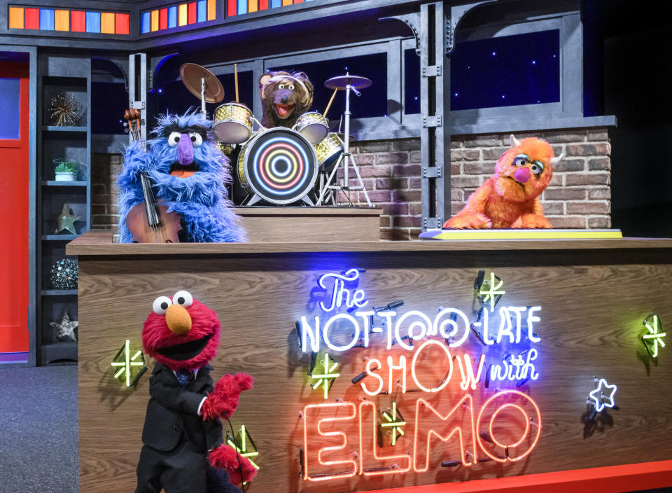 This image released by Sesame Workshop shows muppet character Elmo, bottom left, who will host a family friendly show called “The Not Too Late Show with Elmo.” It begins streaming May 27 on HBO Max. (Zach Hyman/Sesame Workshop via AP)