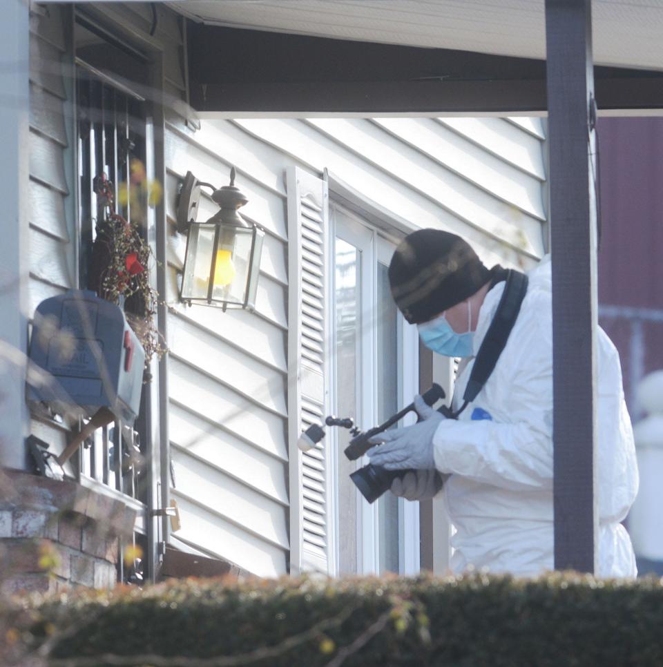 A member of the State Police Major Crime Unit videotapes outside and inside 40 School Street in downtown Norwich Monday where a fatal shooting happened Sunday night.