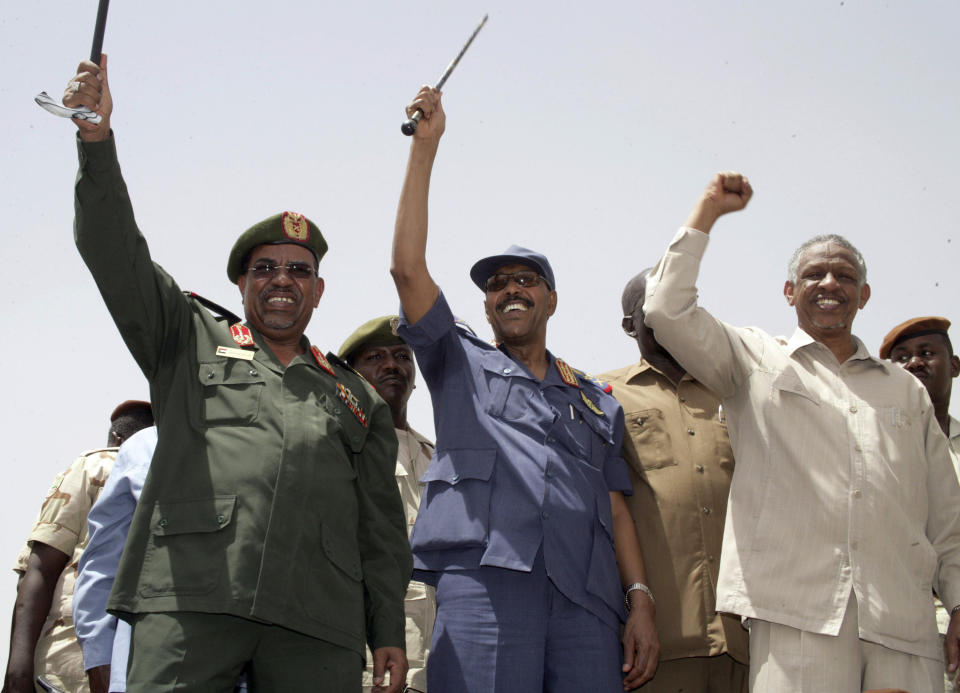 FILE - In this May 14, 2008 file photo, then Sudan's President Omar al-Bashir, Defense Minister Gen. Abdul-Rahim Mohammed Hussein, and Deputy Chairman of the National Congress Party Nafi Ali Nafi, from left to right, address a state-orchestrated rally in the capital Khartoum, Sudan. Activists are calling for mass protests in the capital, Khartoum, and elsewhere across the country to demand the disbanding of the National Congress Party. The Sudanese Professionals' Association, which spearheaded the uprising against Bashir's rule, said the protests Monday, Oct. 21, 2019, will also renew demands to step up an independent investigation into the deadly break-up of protests in June. (AP Photo/Abd Raouf, File)