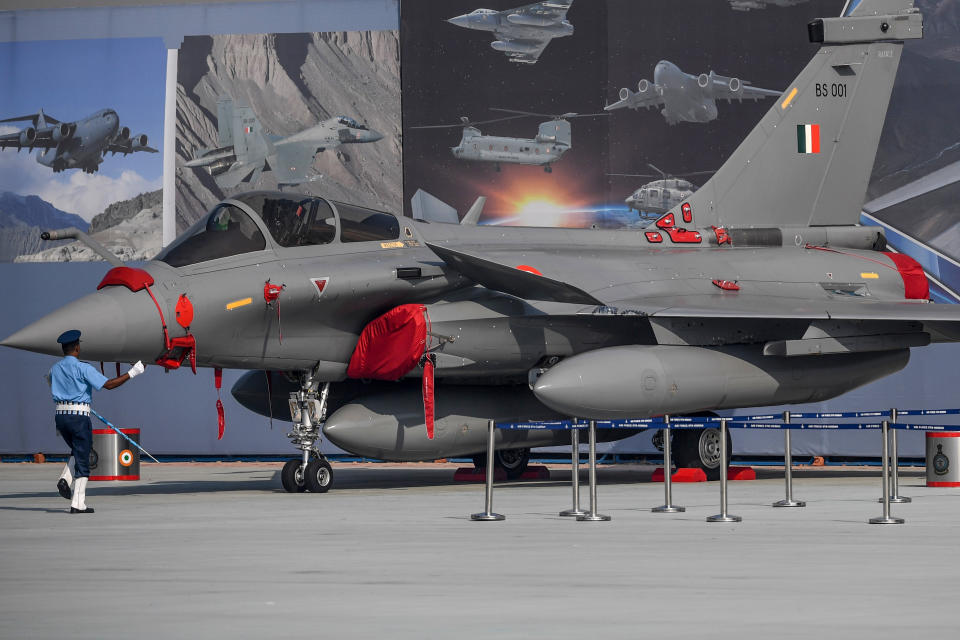 A member of the Indian Air Force (IAF) band performs next to the newly launched Rafale fighter jet during the 88th Air Force Day parade at Hindon Air Force station in Ghaziabad on October 8, 2020. (Photo by Money SHARMA / AFP) (Photo by MONEY SHARMA/AFP via Getty Images)