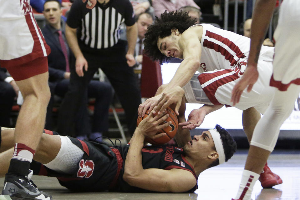 Stanford forward Oscar da Silva, bottom, and Washington State forward CJ Elleby try and gain possession of the ball during the second half of an NCAA college basketball game in Pullman, Wash., Sunday, Feb. 23, 2020. Stanford won 75-57. (AP Photo/Young Kwak)