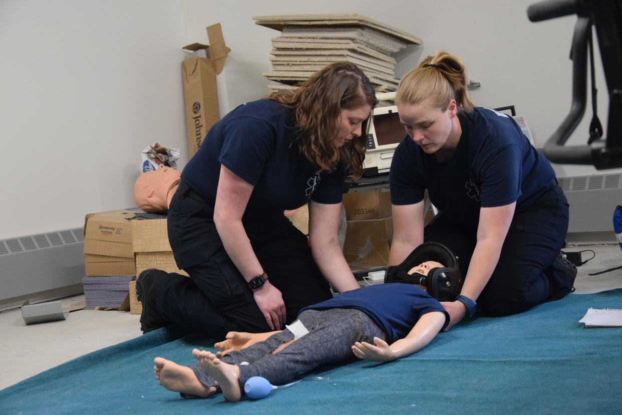 Laurie Kirby and Ashley Shumaker examine the practice dummy during their final training scenario on Thursday, May 2, 2024.