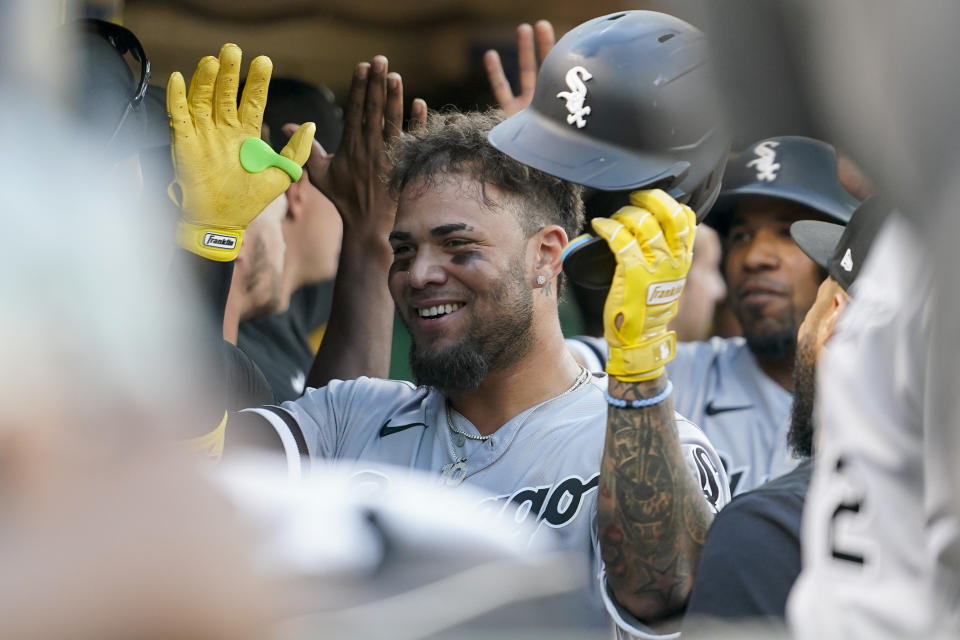 Chicago White Sox's Yoán Moncada celebrates with teammates in the dugout after hitting a three-run home run against the Oakland Athletics during the second inning of a baseball game in Oakland, Calif., Thursday, Sept. 8, 2022. (AP Photo/Godofredo A. Vásquez)