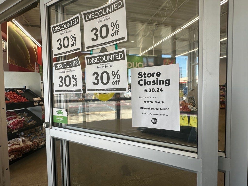 A sign on the door of the Save A Lot in West Allis announces that the store will be closing on May 20.