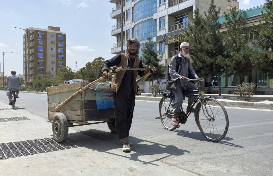Sal Mohammad, 25, an Afghan man who gathers pieces of iron from the street to sell for scrap, pushes his handcart in Kabul, Afghanistan, Tuesday, Aug. 31, 2021. (AP Photo/Sayed Ziarmal Hashemi)