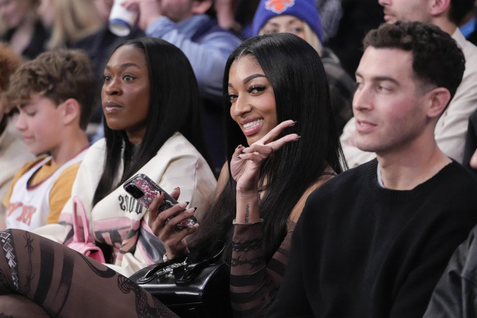 LSU basketball forward Angel Reese, gestures at photographers during a time out in the second half of an NBA basketball game between the New York Knicks and the Brooklyn Nets, Friday, April 12, 2024, at Madison Square Garden in New York. The Knicks won 111-107. (AP Photo/Mary Altaffer)