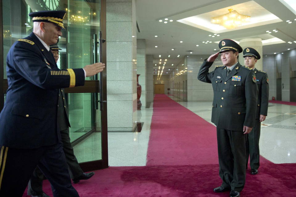 U.S. Army Chief of Staff Gen. Raymond Odierno, left, is saluted by Gen. Wang Ning, right, deputy Chief Staff of the People's Liberation Army (PLA), upon his arrival at China's Ministry of Defense in Beijing, Friday, Feb. 21, 2014. The U.S. Army chief met with top Chinese generals in Beijing Friday amid regional tensions and efforts to build trust between the two nation's militaries. (AP Photo/Alexander F. Yuan, Pool)