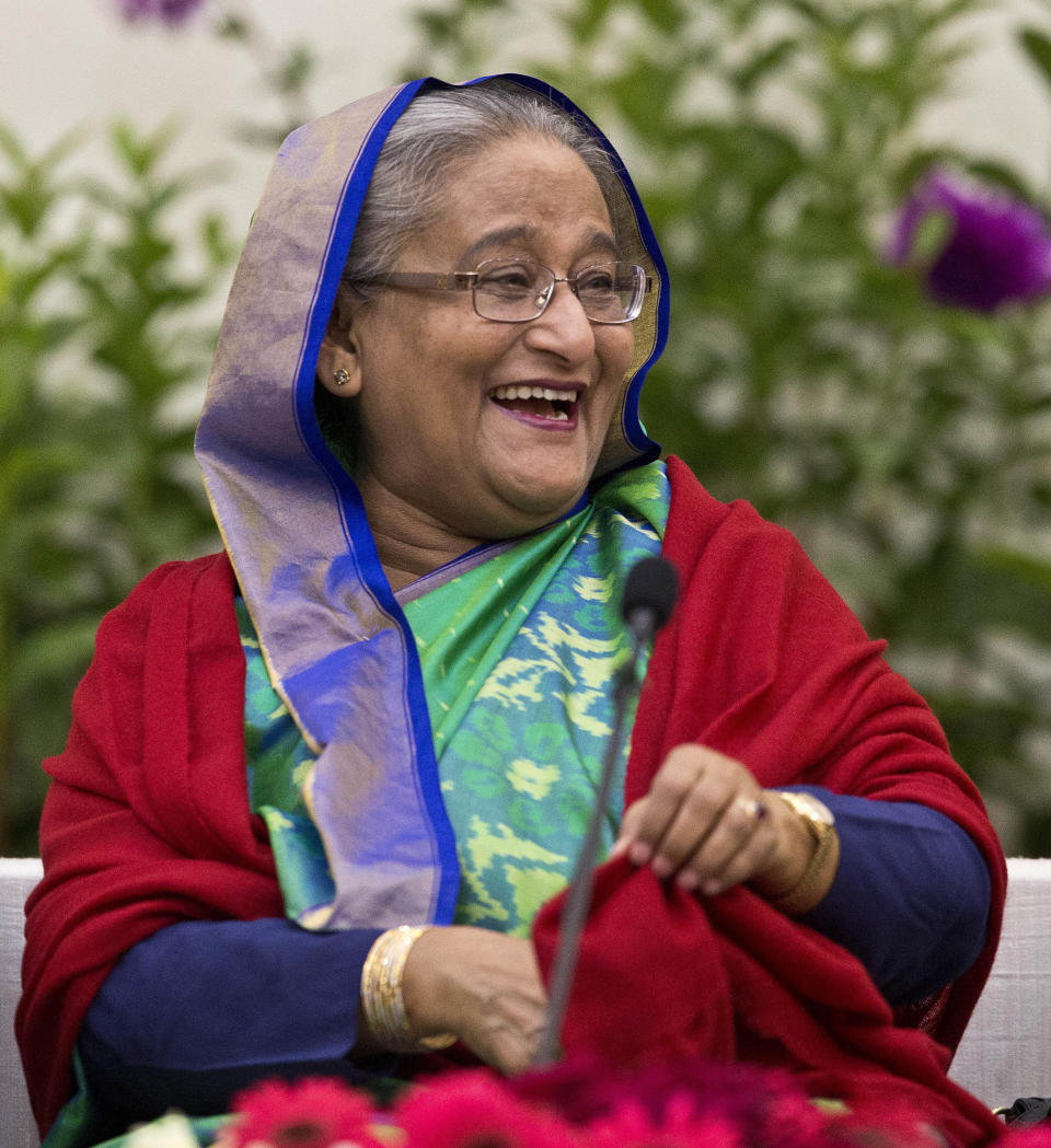 Bangladeshi Prime Minister Sheikh Hasina interacts with journalists in Dhaka, Bangladesh, Monday, Dec. 31, 2018. Bangladesh's ruling alliance won virtually every parliamentary seat in the country's general election, according to official results released Monday, giving Hasina a third straight term despite allegations of intimidation and the opposition disputing the outcome. (AP Photo/Anupam Nath)