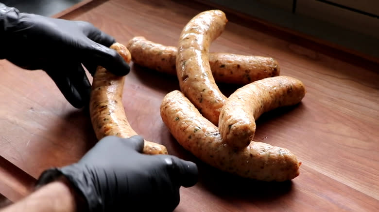 Chicken sausages on cutting board