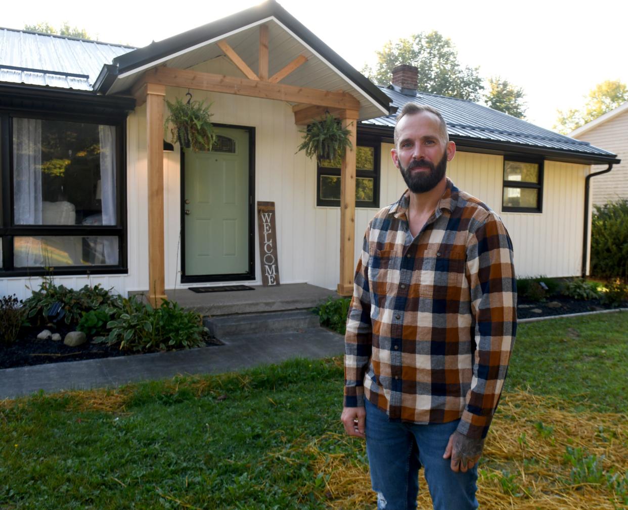 Realtor Kenny Mayle outside Lake Township home which has been remodeled in a modern farmhouse style. Wednesday, Oct. 4, 2023