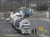 FILE - In this Feb. 11, 2016, file photo, South Korean vehicles returning from North Korea's joint Kaesong Industrial Complex pass the customs, immigration and quarantine office near the border village of Panmunjom in Paju, South Korea. North Korean leader Kim Jong Un has two urgent concerns as he heads to the summit with Russian President Vladimir Putin for their first one-on-one meeting. Kim also pushed Seoul hard to participate in joint inter-Korean projects to rebuild its railroads and improve its moribund infrastructure. (AP Photo/Ahn Young-joon, File)