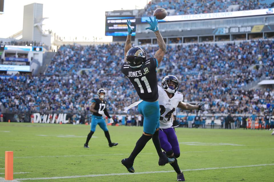 Jacksonville Jaguars wide receiver Marvin Jones Jr. (11) hauls in a reception score against Baltimore Ravens cornerback Marcus Peters (24) during the fourth quarter of a regular season NFL football matchup Sunday, Nov. 27, 2022 at TIAA Bank Field in Jacksonville. The Jaguars edged the Ravens 28-27. [Corey Perrine/Florida Times-Union]