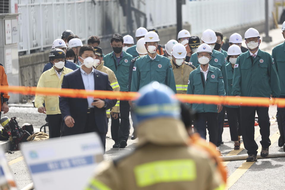 South Korean Prime Minister Han Duck-soo, top center, arrives at the site of a fire at a lithium battery manufacturing factory in Hwaseong, South Korea, Monday, June 24, 2024. (Ryu Hyung-seok/Yonhap via AP)