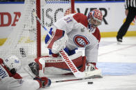 FILE - In this Wednesday, July 7, 2021 file photo, Montreal Canadiens goaltender Carey Price (31) plays the puck during the first period in Game 5 of the NHL hockey Stanley Cup finals against the Tampa Bay Lightning, in Tampa, Fla. After backstopping the Montreal Canadiens to the Stanley Cup Final, Price has been left unprotected for the Seattle Kraken expansion draft. Price agreed to be exposed so the Canadiens could protect cheaper backup Jake Allen. The league released the protected lists of all 30 teams eligible for the expansion draft Sunday morning, July 18. (AP Photo/Phelan Ebenhack, File)