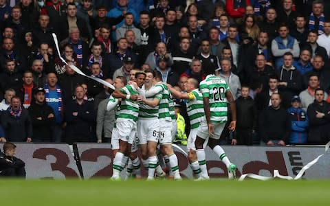 Celtic players celebrate as they crush Rangers at Ibrox - Credit: Reuters