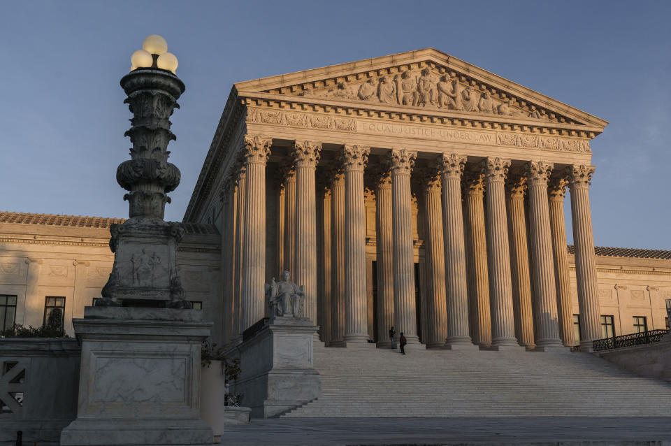 FILE - In this Friday, Nov. 6, 2020 file photo, The Supreme Court is seen at sundown in Washington. The Supreme Court is telling California it can't enforce a ban on indoor church services because of the coronavirus pandemic. The high court issued orders late Friday, Feb. 5, 2021 in two cases where churches had sued over coronavirus-related restrictions in the state. (AP Photo/J. Scott Applewhite, File)