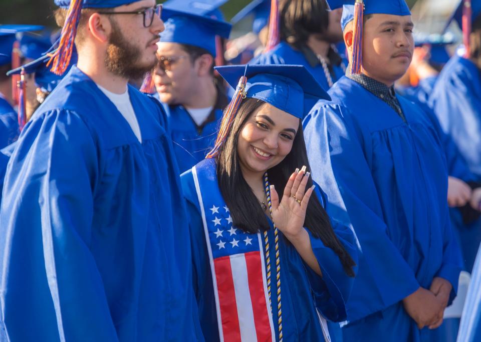 Fatima Castillo, a member of the Class of 2023 at Keefe Regional Technical High School, sneaks in a wave during the school's 50th graduation ceremony Wednesday at the Warren Conference Center and Inn in Ashland, May 31, 2023.