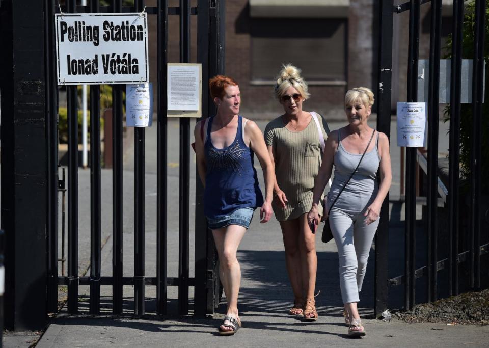 Voters make their way to and from a polling station situated at St Anne's national school in Dublin (Getty Images)