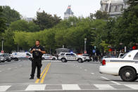 Law enforcement officials gather following a shooting that took place at 17th Street and Pennsylvania Avenue near the White House, Monday, Aug. 10, 2020, in Washington. (AP Photo/Patrick Semansky)