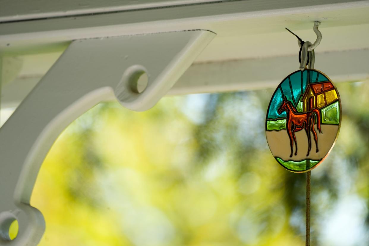 A stained glass horse hangs from Pam Robinson’s mother’s gazebo in her front yard.