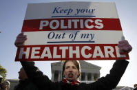 Amy Brighton from Medina, Ohio, who opposes health care reform, rallies in front of the Supreme Court.