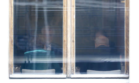 Leader of the Christian Democratic Union of Germany (CDU) Angela Merkel and leader of the Christian Social Union in Bavaria (CSU) Horst Seehofer are seen through the window during the CDU and CSU exploratory talks about forming a new coalition government in Berlin, Germany, October 18, 2017. REUTERS/Hannibal Hanschke