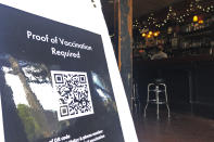 A proof of vaccination sign is posted at a bar in San Francisco on Thursday, July 29, 2021. Until now, many employers had taken a passive approach to their unvaccinated workers, relying outreach and incentives. But that has been shifting, with vaccine mandates gaining momentum. (AP Photo/Haven Daley)