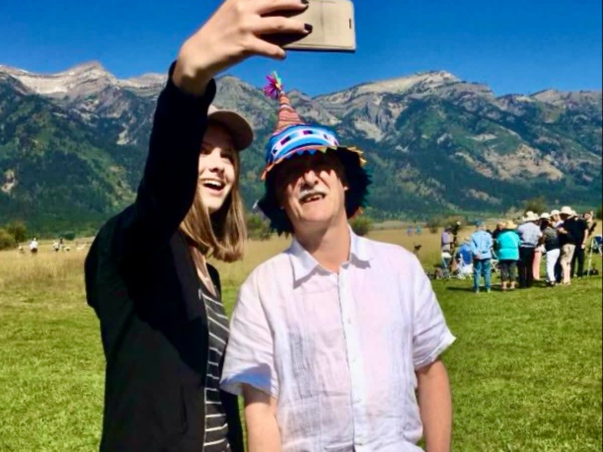 Selfie star: Dr John Mason, wearing his special eclipse headgear, with a young astronomical fan in Wyoming ahead of the 2017 eclipse (Simon Calder)