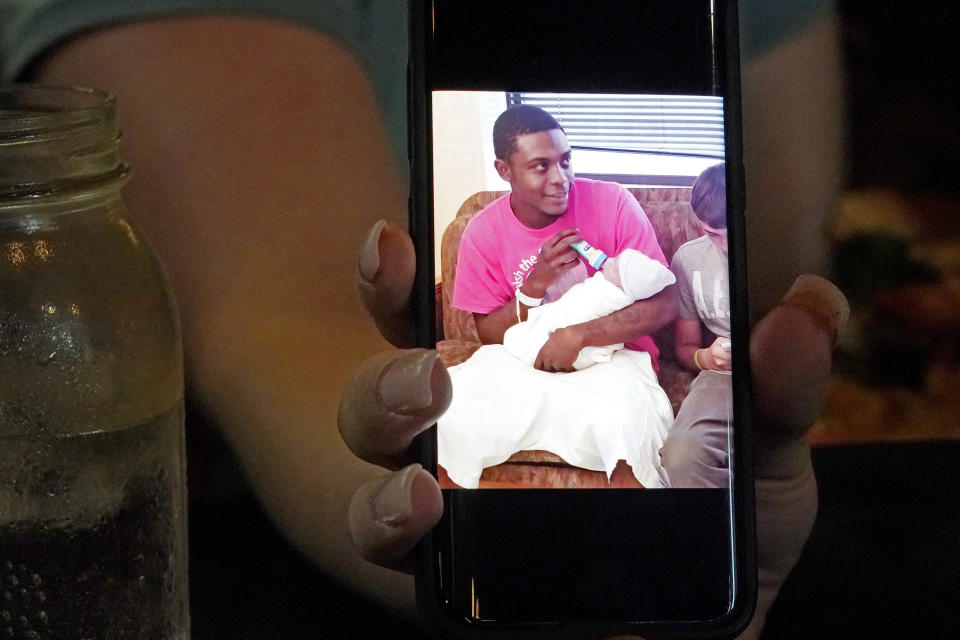 Alexis Rankin holds a 2018 cell phone photograph of her former boyfriend Willie Jones Jr., holding their newborn son, as she recalls the events of February 8, 2018, when Jones was discovered hanging from a tree in the yard of Rankin's family home shortly after arriving there with Rankin. The sheriff's department and the Mississippi Bureau of Investigation, both ruled the death a suicide. However, a Jackson-area judge in April awarded close to $11.4 million to Jones' family in a civil suit claiming wrongful death, alleging that Rankin's stepfather, Harold O'Bryant, Jr., either killed Jones or failed to prevent him from killing himself. (AP Photo/Rogelio V. Solis)