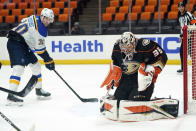 Anaheim Ducks goaltender John Gibson, right, stops a shot in front of St. Louis Blues center Oskar Sundqvist (70) during the first period of an NHL hockey game Wednesday, March 3, 2021, in Anaheim, Calif. (AP Photo/Marcio Jose Sanchez)