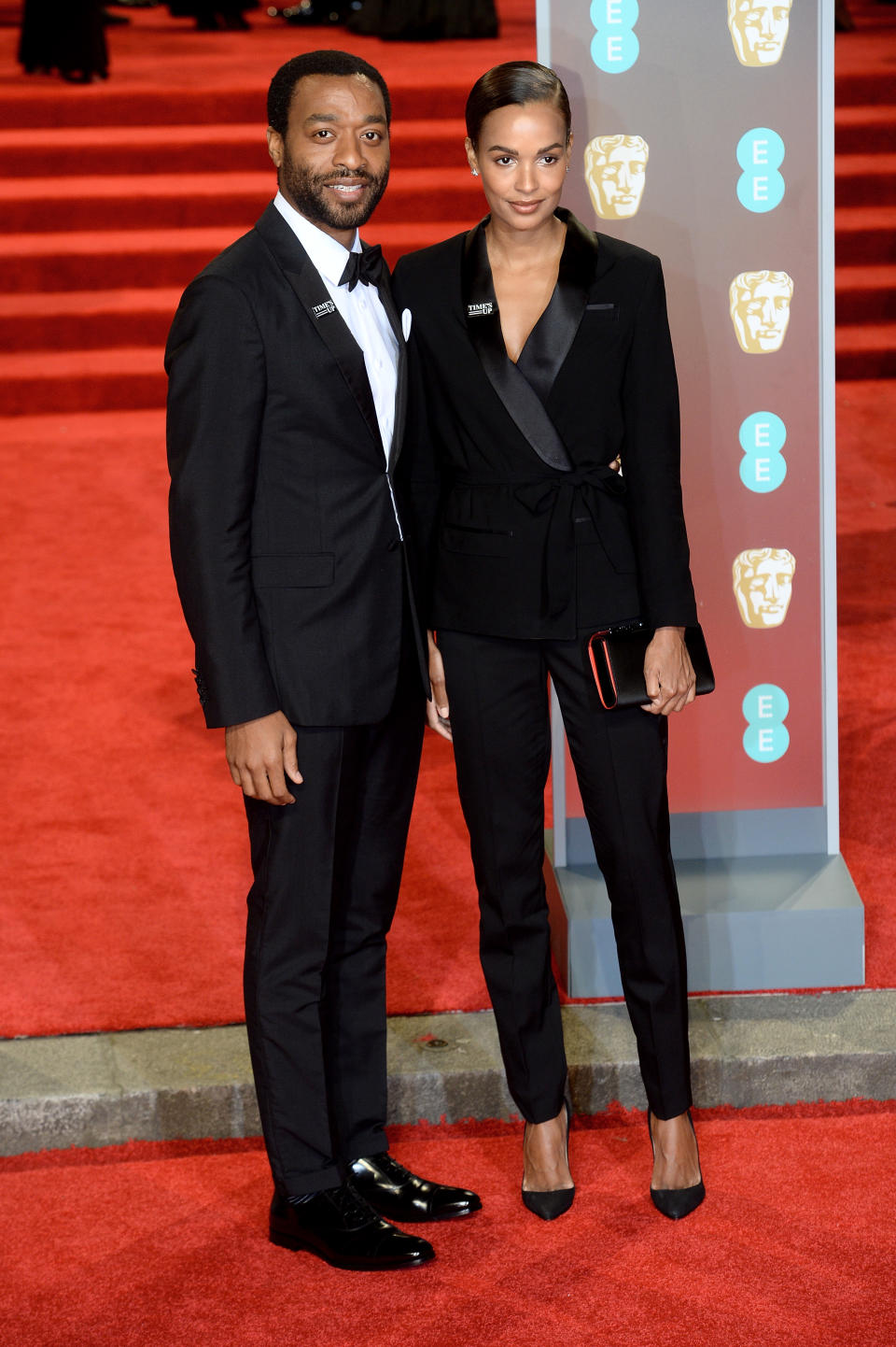 <p>The actor and his model flame coordinated in trouser suits. <em>[Photo: Getty]</em> </p>