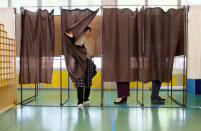 A woman leaves a polling booth as she votes in the first round of 2017 French presidential election at a polling station in Vaulx-en-Velin near Lyon, France, April 23, 2017. REUTERS/Emmanuel Foudrot