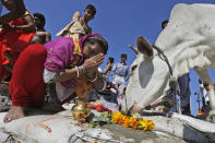 <p>An Indian woman prays to a holy cow after taking a holy dip at the Sangam, the confluence of the Ganges and Yamuna and the mythical Saraswati, on the occasion of Hindu festival of Maha Shivaratri, that marked the last day of the annual traditional fair of Magh Mela, in Allahabad, India , Friday, Feb. 24, 2017. Shivaratri, or the night of Shiva, is dedicated to the worship of Lord Shiva, the Hindu god of death and destruction. (AP Photo/Rajesh Kumar Singh) </p>