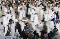 In this photo taken with low shutter speed, Muslim pilgrims circumambulate around the Kaaba, the cubic building at the Grand Mosque, in Mecca, Saudi Arabia, Wednesday, July 6, 2022. Muslim pilgrims are converging on Saudi Arabia's holy city of Mecca for the largest hajj since the coronavirus pandemic severely curtailed access to one of Islam's five pillars. (AP Photo/Amr Nabil)