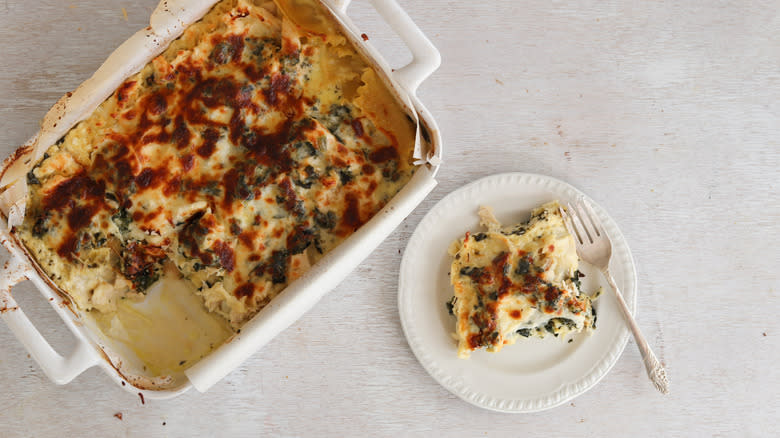 spinach and chicken lasagna sliced from baking dish