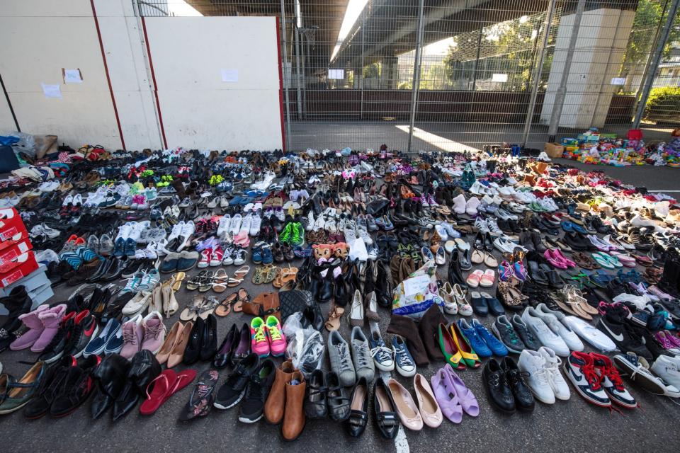 <p>Donated shoes sit in the Westway Sports Center near to the site of the Grenfell Tower fire on June 15, 2017 in London, England. (Photo: Jack Taylor/Getty Images) </p>