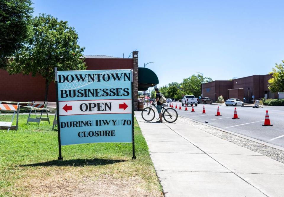 A sign lets visitors know that business in Marysville are open as they struggle with the closure of Highway 70 in downtown on Monday.