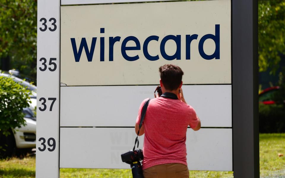 A news photographer takes photos of a Wirecard sign - Michaela Handrek-Rehle /Bloomberg