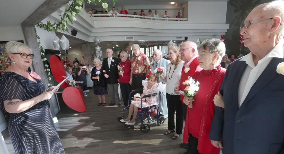 Wedding officiant Barbara Lovelace speaks to senior couples renewing their wedding vows on Valentine's Day at the CountrySide Lakes Senior Living in Port Orange. The couples, from left to right: Marie & Mike Helland; Joan & Don Daigneault; Ellie & Clarence Bloom; Marsha & Stewart Spar; and Janet & Sharkey Thomas.