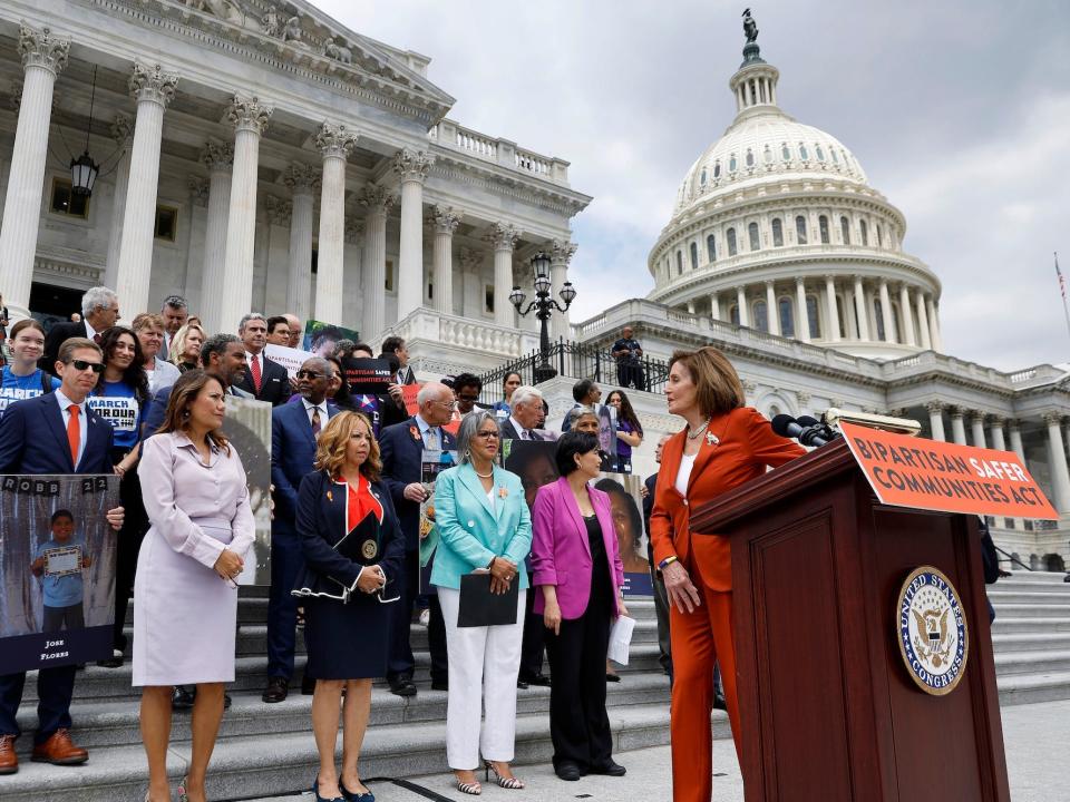House Speaker Nancy Pelosi leads a rally celebrating the passage of gun safety legislation as protesters swarm the court just yards away on June 24, 2022.