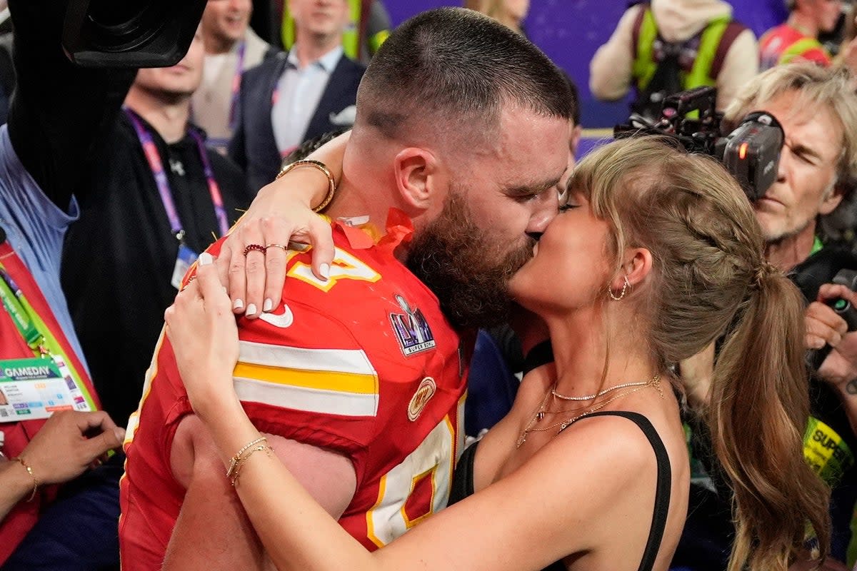 Kansas City Chiefs tight end Travis Kelce kisses girlfriend Taylor Swift after his side’s 25-22 Super Bowl victory over the San Francisco 49ers on Sunday, February 11, 2024 (AP)