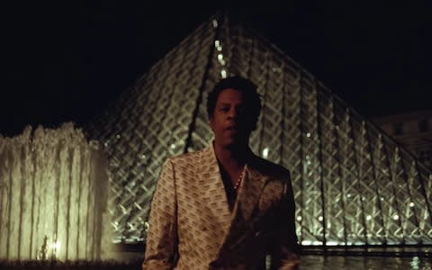 Jay-Z in front of the Louvre's famed pyramid entrance - Credit: Telegraph