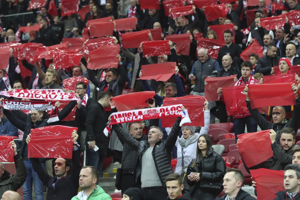 FILE - In this Tuesday, Nov. 19, 2019 file photo, Polish fans cheer their team during the Euro 2020 group G qualifying soccer match between Poland and Slovenia at the National stadium in Warsaw, Poland. For players, the pandemic has meant a congested season that poses fitness challenges, let alone trying to avoid coronavirus infections. Financially playing the delayed tournament is essential for UEFA. For fans, the EURO 2020 24-team event should be the first chance for the widespread return of fans to stadiums across Europe since March 2020, assuming new restrictions aren't imposed. (AP Photo/Czarek Sokolowski, File)