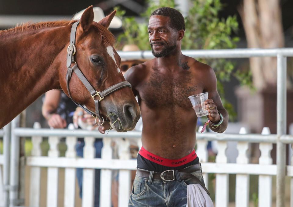 Anthony Harris of the Compton Cowboys works with one of the group’s horses during the Stagecoach country music festival in Indio, Calif., Friday, April 29, 2022.