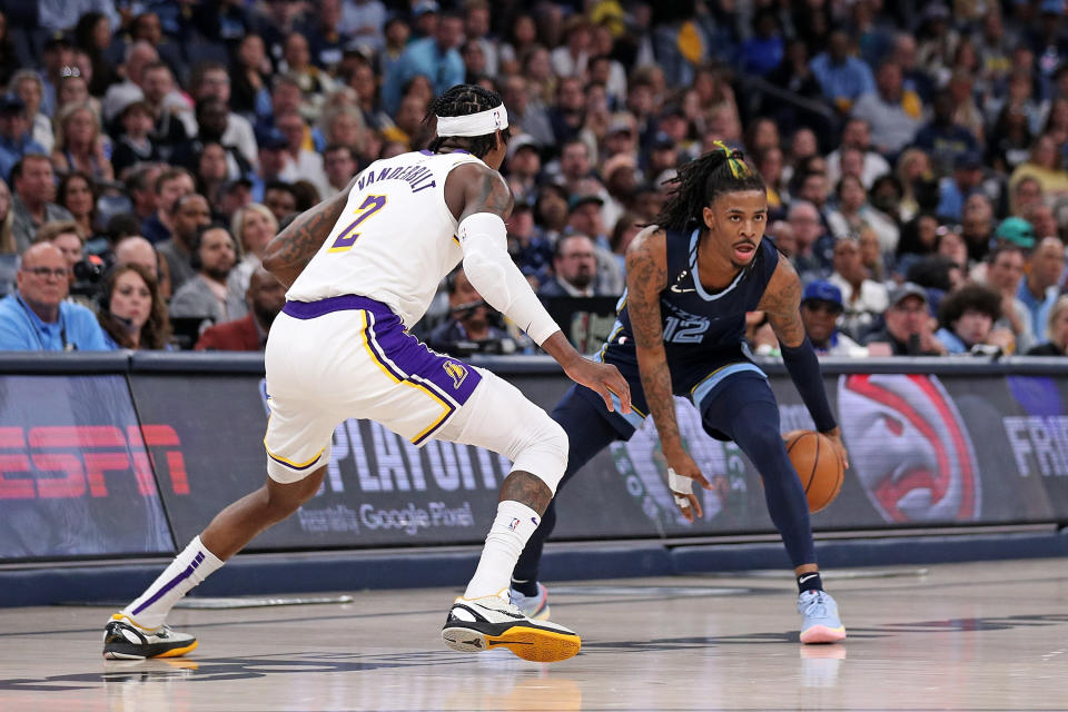 MEMPHIS, TENNESSEE - APRIL 16: Ja Morant #12 of the Memphis Grizzlies handles the ball against Jarred Vanderbilt #2 of the Los Angeles Lakers during the second half of Game One of the Western Conference First Round Playoffs at FedExForum on April 16, 2023 in Memphis, Tennessee. NOTE TO USER: User expressly acknowledges and agrees that, by downloading and or using this photograph, User is consenting to the terms and conditions of the Getty Images License Agreement.  (Photo by Justin Ford/Getty Images)
