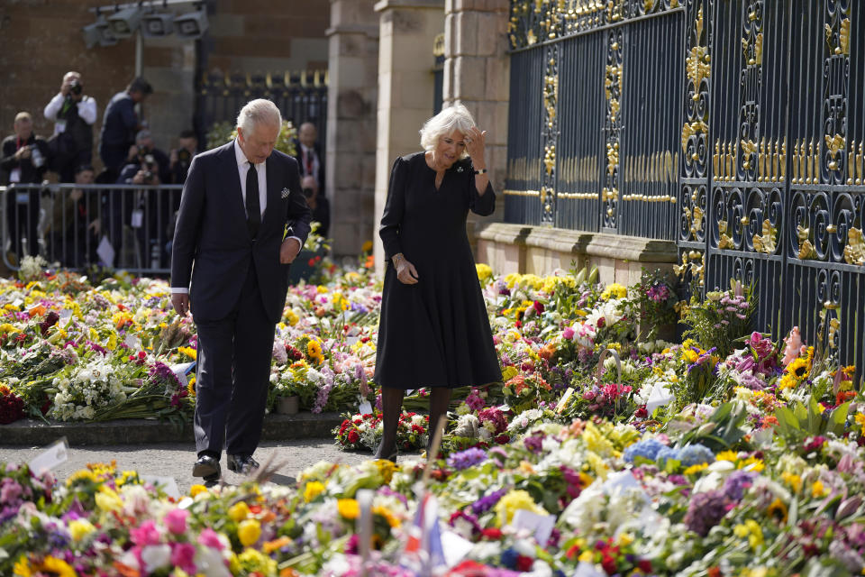 King Charles III and the Queen Consort view floral tributes left outside Hillsborough Castle, Co Down, following the death Queen Elizabeth II on Thursday. Picture date: Tuesday September 13, 2022.