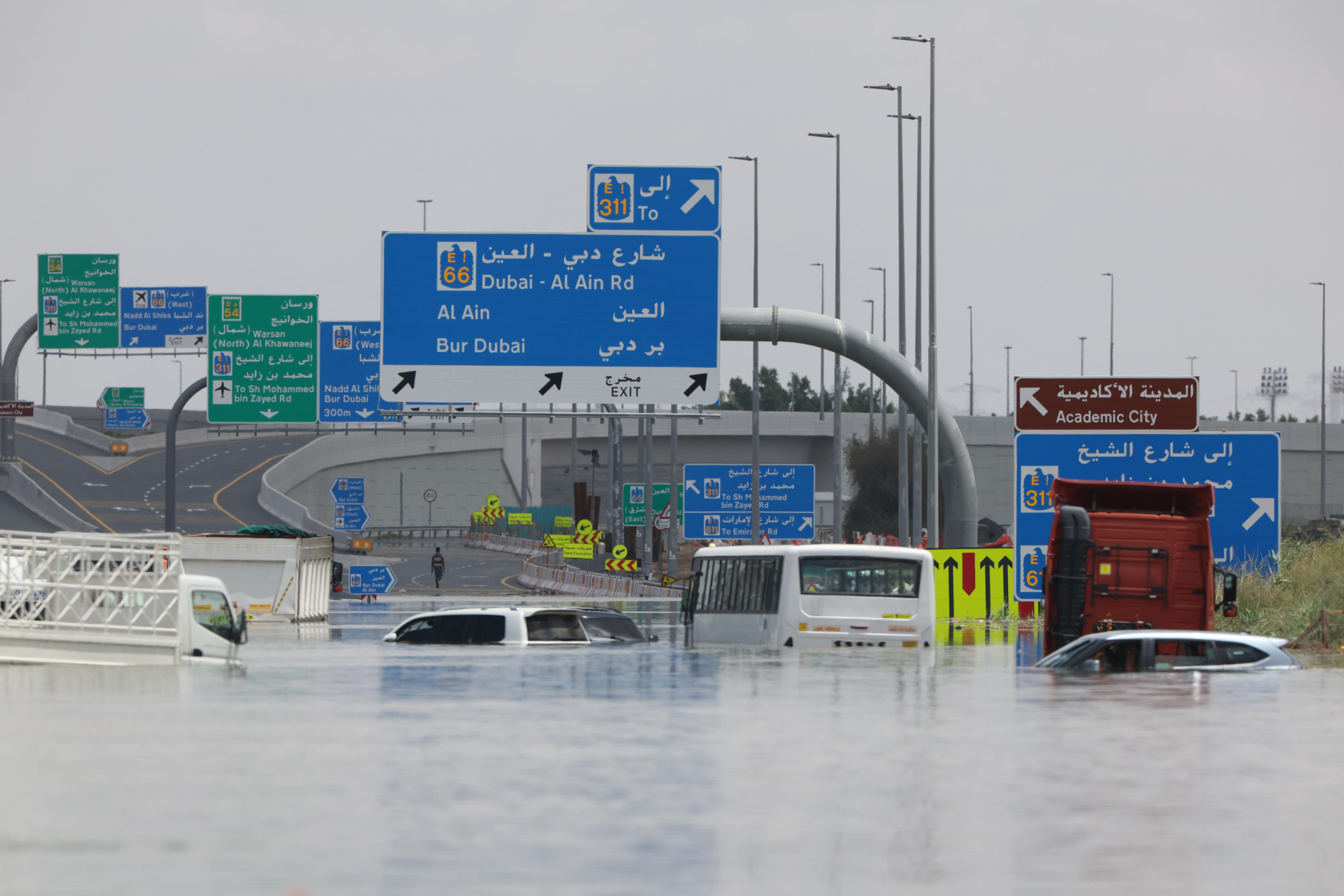 Abandoned vehicles are seen on a flooded highway near the Dubai airport.